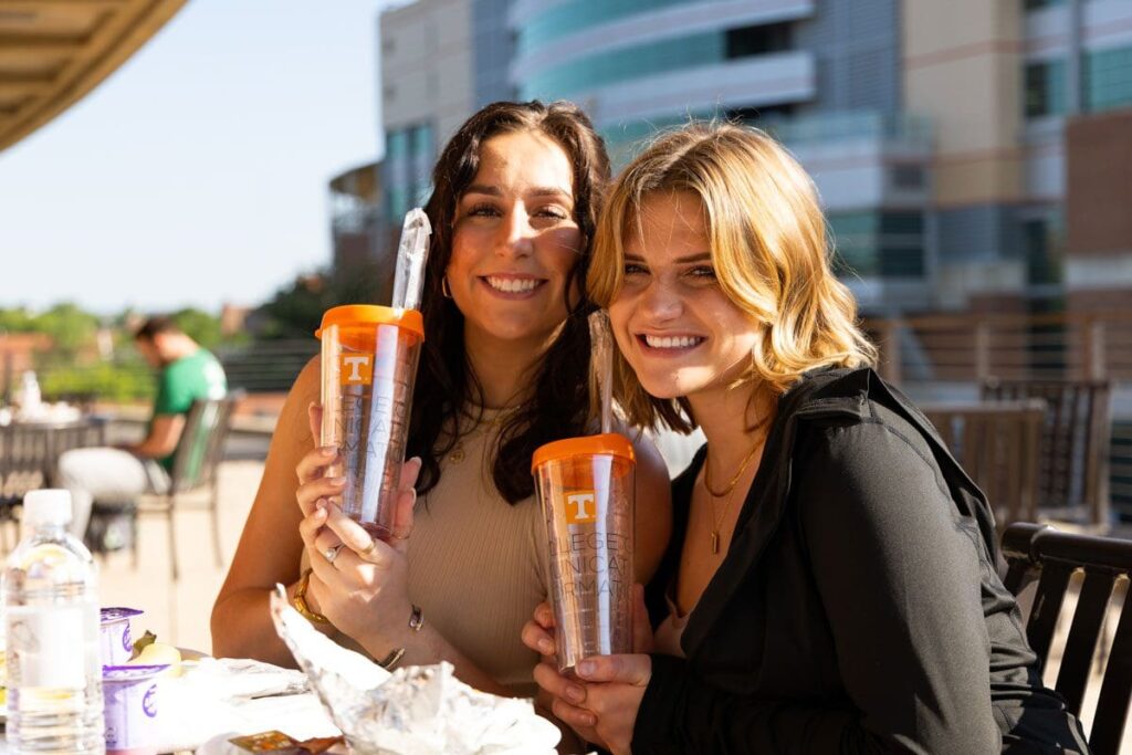 Two students hold up CCI cups.